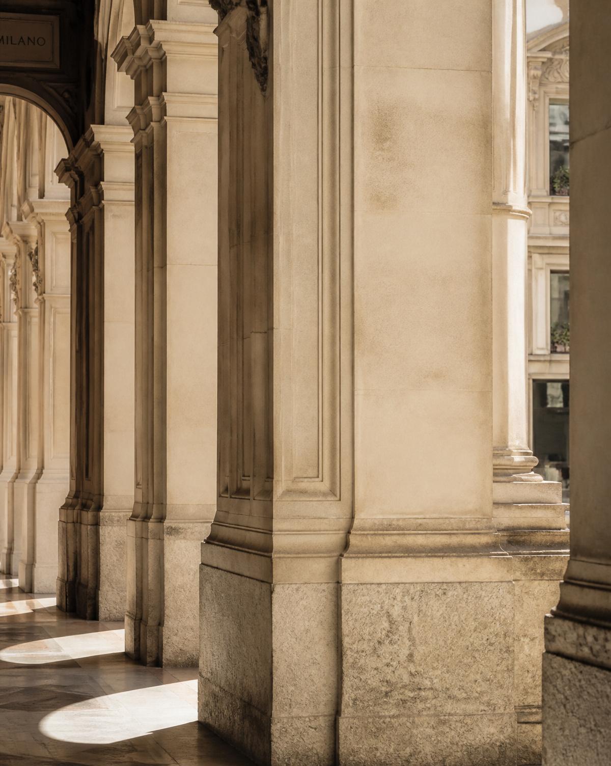 Classic Milanese stone arcade with soft daylight